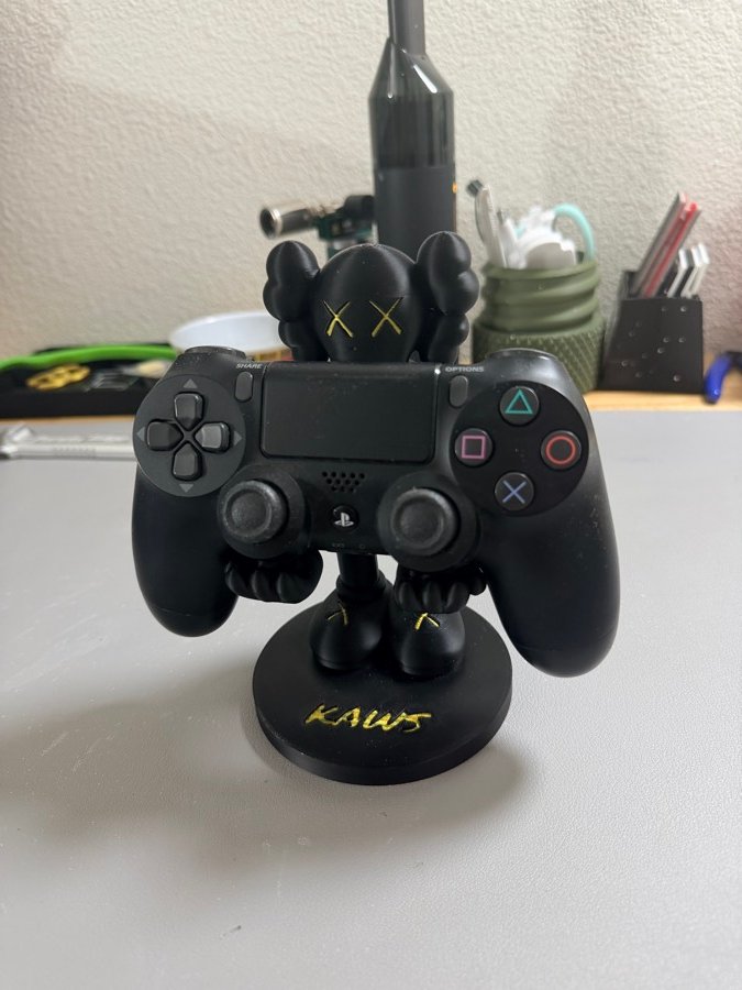 Figure-style game controller holder with a custom base