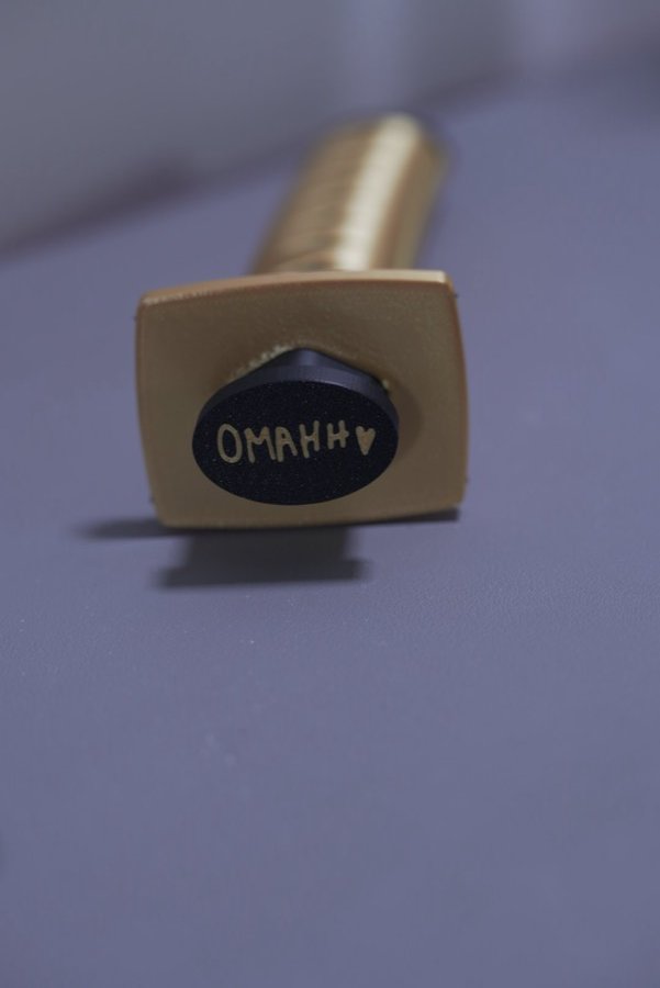 Gold handle with a custom printed name cap