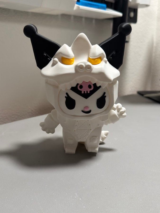 Kitty figure in a white monster costume