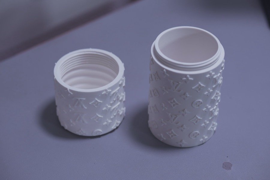 Open white textured canister showing the threaded lid