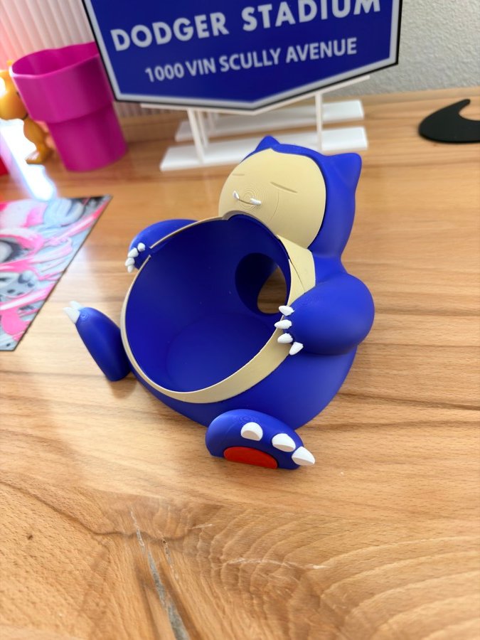 Blue sleeping character bowl on a wooden table