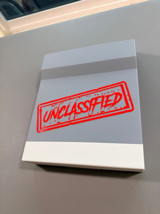 Gift box with a red UNCLASSIFIED stamp on the lid
