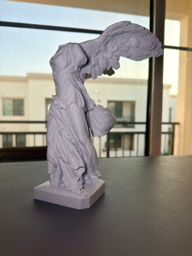 Printed Winged Victory statue by a window
